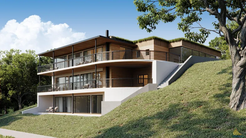 Moderne Villa mit mehreren Balkonen und Terrassen, eingebettet in eine grüne Hügellandschaft.