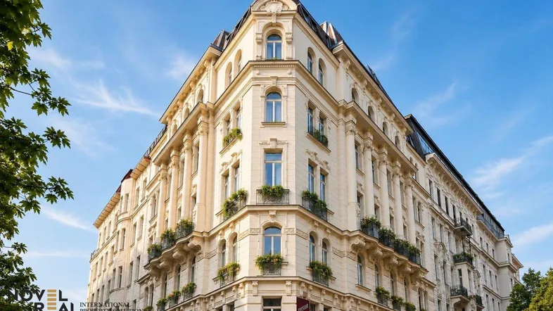 Elegantes Eckgebäude mit klassischer Architektur und verzierten Fassadendetails unter blauem Himmel.