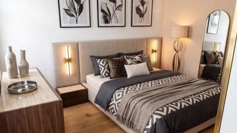 Helles Schlafzimmer mit Holzboden, modernem Bett, stilvoller Dekoration und hohen Decken.