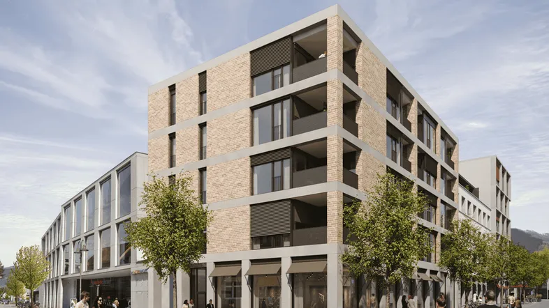 Moderne Wohn- und Geschäftshäuser mit Ziegelfassade und großen Fenstern an einer belebten Straße.