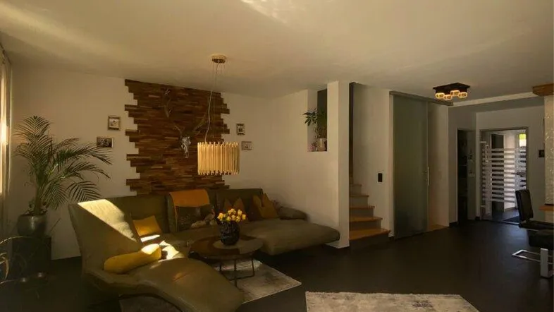 Großzügiges Wohnzimmer mit stilvoller Wandgestaltung in Holz