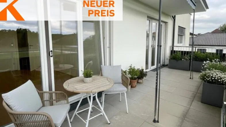 Heller Balkon mit modernen Sitzgelegenheiten, Pflanzen und weitem Blick ins Grüne.
