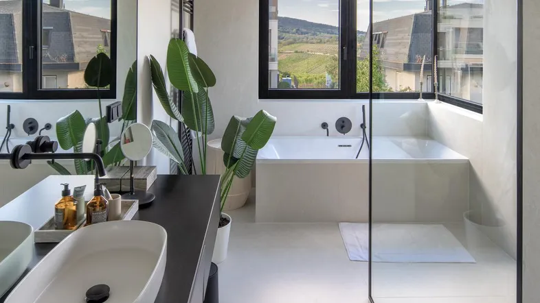 Modernes Badezimmer mit integrierter Badewanne, Einzelwaschbecken und großem Fenster mit Weitblick.