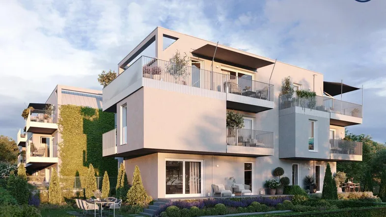 Moderne Wohnanlage mit begrünten Fassaden, großzügigen Terrassen und einem gepflegten Gartenbereich.