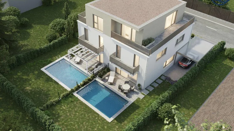 Moderne Villa aus der Vogelperspektive mit zwei Pools, Carport und gepflegtem Gartenbereich.