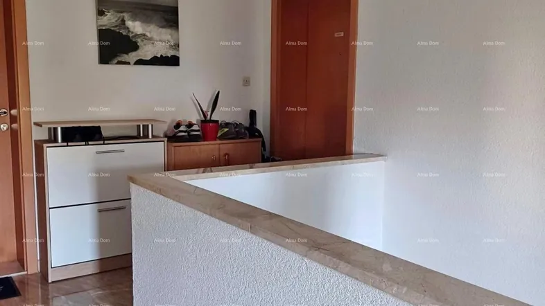 Heller Flur mit Marmorboden, Schuhschrank und Holztüren, der zu weiteren Räumen führt.
