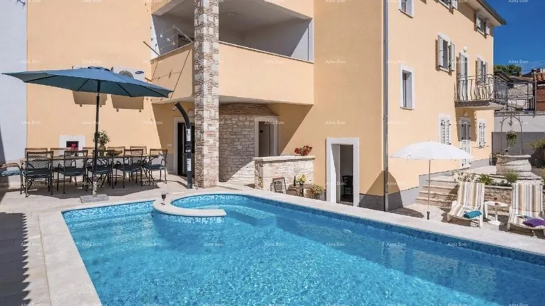 Außenbereich mit Swimmingpool, Sonnenschirmen und Essbereich, ideal für Entspannung im Freien.