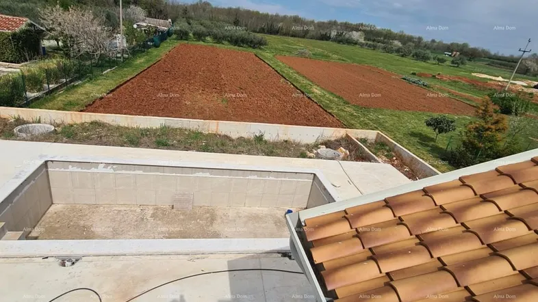 Blick von oben auf eine Baustelle mit zukünftigem Poolbereich, umgeben von Feldern und Natur.