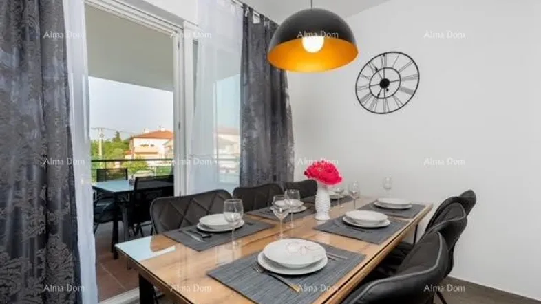 Moderner Essbereich mit Holztisch, sechs Stühlen und Zugang zu einem Balkon.