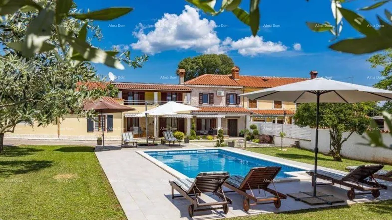 Großzügiger Gartenbereich mit privatem Pool, Sonnenliegen und einem charmanten Haus im Hintergrund.