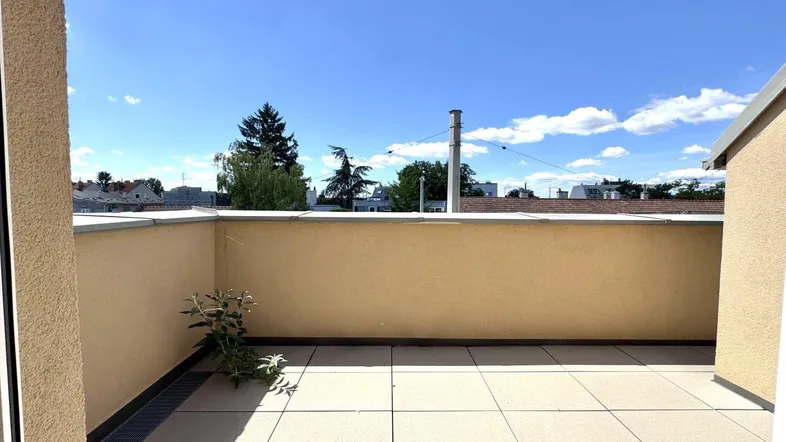 Große, sonnige Terrasse mit Fliesenboden und weitem Blick über die Umgebung.