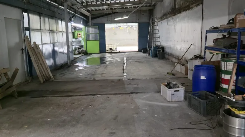 Große, leere Lagerhalle mit Betonboden und Wellblechdach, bereit zur Nutzung und vielseitig einsetzbar.