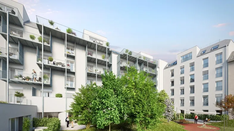 Moderne Wohnanlage mit mehreren Balkonen, begrünten Dächern und einem gemeinschaftlichen Gartenbereich mit Spielplatz.