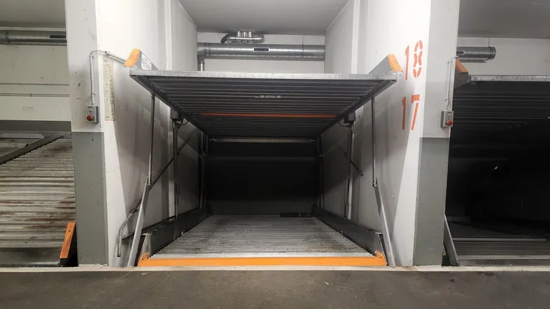 Mechanisches Parksystem in einer Tiefgarage mit zwei Ebenen, bereit zur Nutzung.