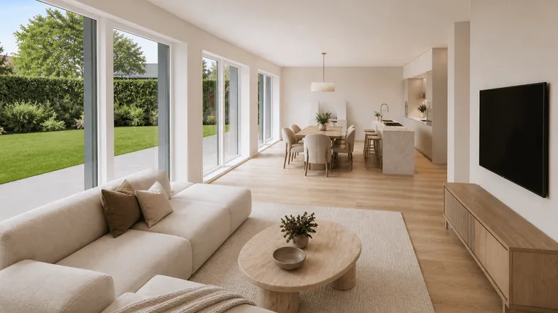 Helles, offenes Wohnzimmer mit Essbereich, moderner Küche und Zugang zum Garten.