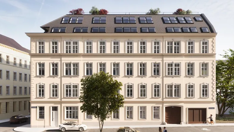 Klassisches Mehrfamilienhaus mit renovierter Fassade und Dachausbau in urbaner Umgebung.
