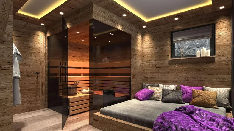 Gemütliches Schlafzimmer im alpinen Stil mit integrierter Sauna, Holzwänden und indirekter Beleuchtung.