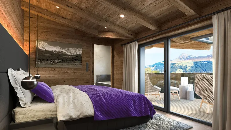 Gemütliches Schlafzimmer im alpinen Stil mit Holzelementen, Bergblick und Zugang zum Balkon.