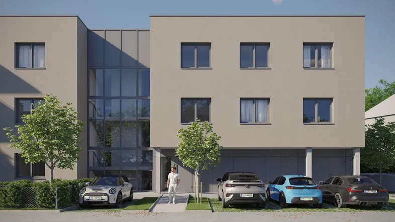 Moderne Wohnanlage mit heller Fassade, großen Fenstern und Parkplätzen vor dem Gebäude.
