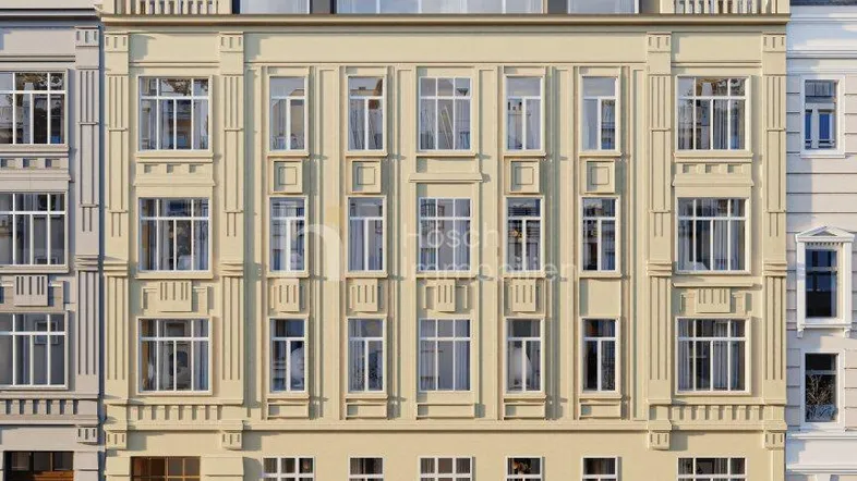 Elegante Fassade eines Mehrfamilienhauses mit Dachausbau und klassischen architektonischen Details an einer Stadtstraße.