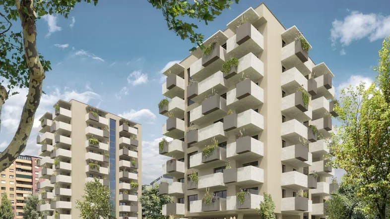 Moderne Wohngebäude mit zahlreichen Balkonen, umgeben von grünen Bäumen und einer gepflegten Gartenanlage.