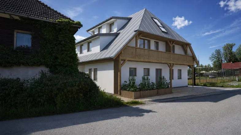 Modernes Gebäude mit Holzdetails und Satteldach in ländlicher Umgebung unter blauem Himmel.