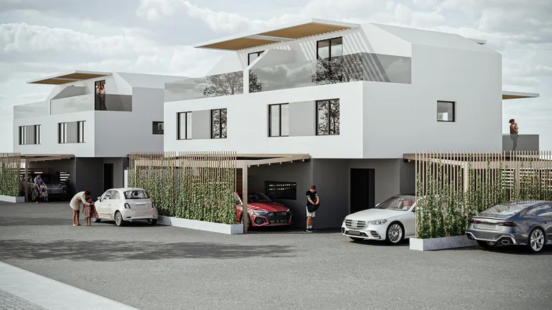 Moderne Reihenhäuser mit Flachdach und Carports in einer Wohnsiedlung.