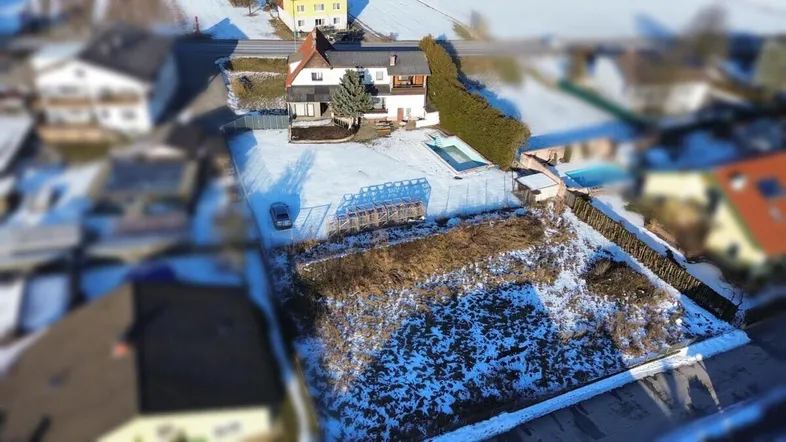 Luftaufnahme des Anwesens mit Haus, Pool und umliegender Landschaft im Winter.