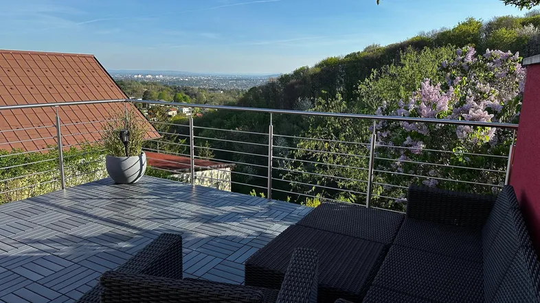 Geräumige Terrasse mit modernen Outdoor-Möbeln und weitem Blick über die Landschaft.