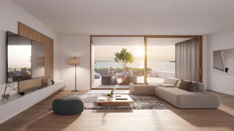 Helles Wohnzimmer mit modernem Design, Holzboden und direktem Zugang zur Terrasse mit Seeblick bei Sonnenuntergang.