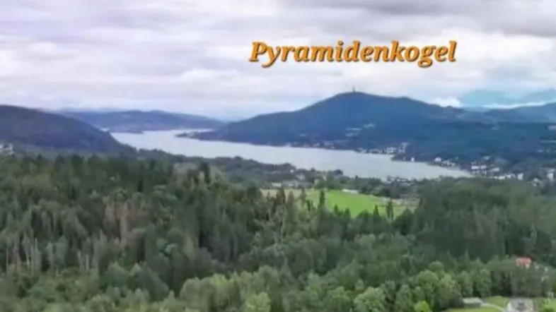 Panoramablick auf den Wörthersee und die umliegende Berglandschaft mit dem Pyramidenkogel.