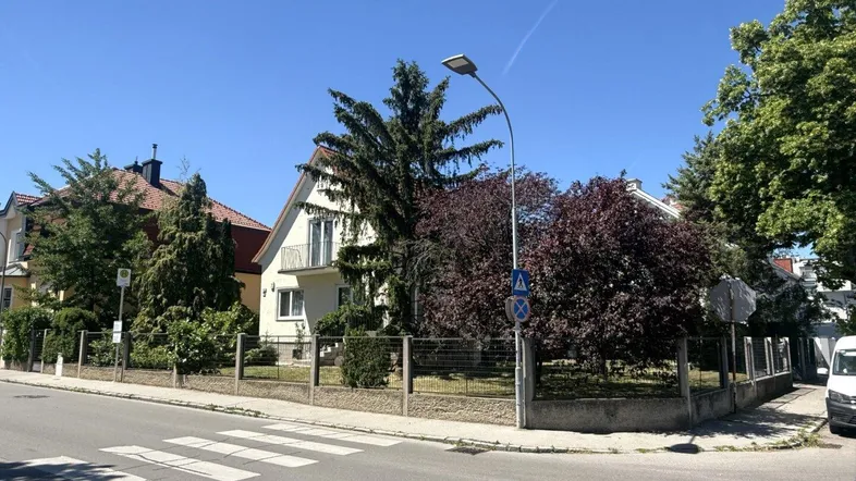 Freistehendes Haus mit Garten und Balkon, von der Straße aus gesehen.