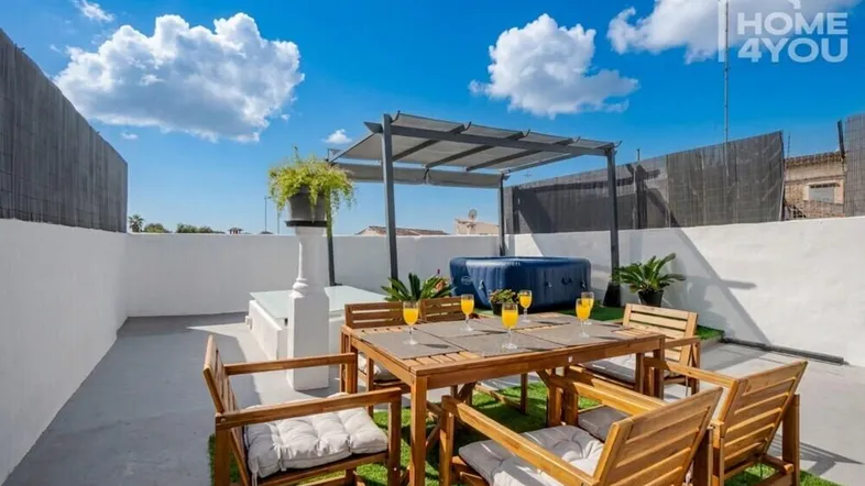 Große Dachterrasse mit Essbereich, Whirlpool und Pergola, ideal für entspannte Stunden im Freien.