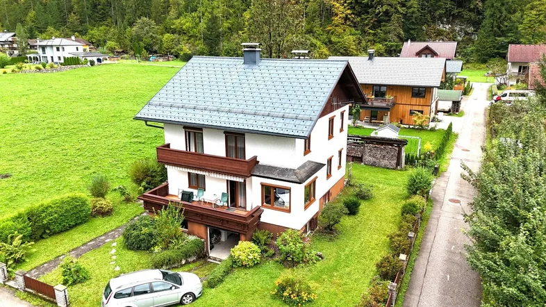 Freistehendes Einfamilienhaus mit Satteldach und Garten in ländlicher Umgebung.