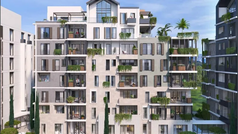 Moderne Wohnanlage mit mehreren Balkonen, viel Grün und zeitgenössischer Architektur.