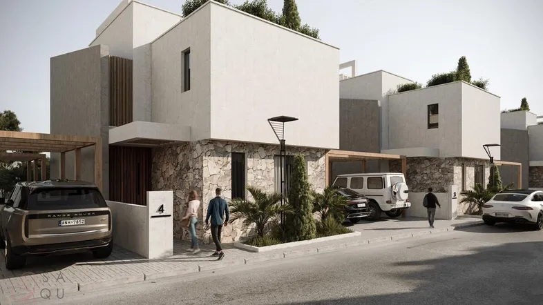 Moderne Reihenhäuser mit weißer Fassade, Steinelementen und begrünten Dächern in einer Wohnsiedlung.