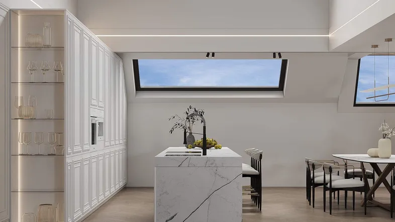 Moderne Küche mit weißer Schrankwand, großer Kochinsel und Essbereich unter einem Dachfenster.