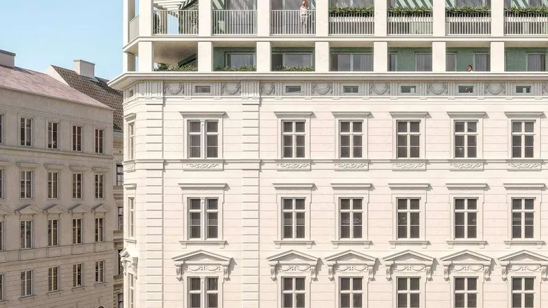 Historisches Gebäude mit modernem Dachausbau und Terrassen in urbaner Umgebung.