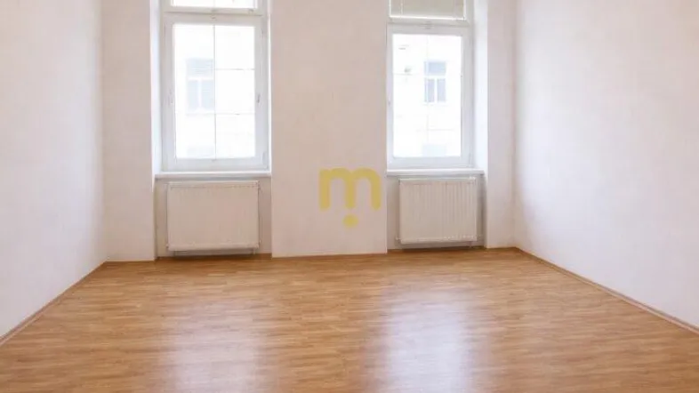 Helles, leeres Zimmer mit zwei Fenstern und Holzboden, bereit zur individuellen Gestaltung.