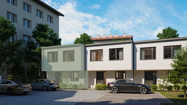 Moderne Reihenhäuser mit weißer Fassade und privaten Parkplätzen vor dem Gebäude.