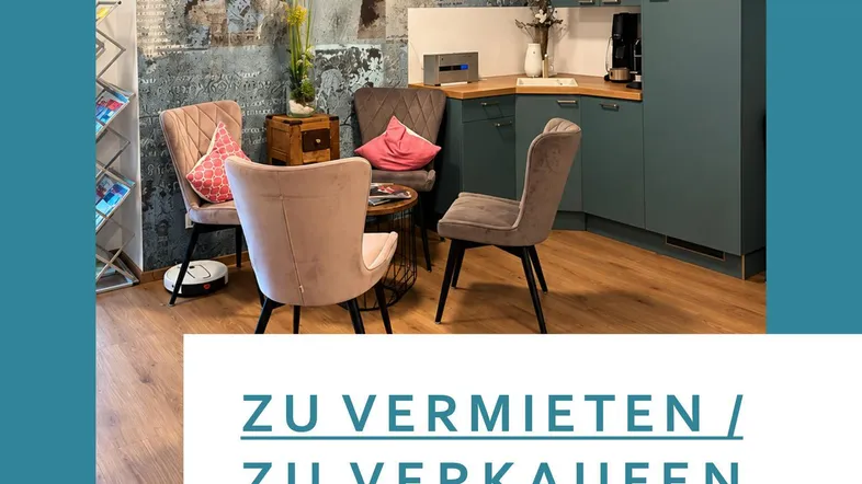 Moderner Empfangsbereich mit integrierter Teeküche, stilvoller Wandgestaltung und bequemen Sitzgelegenheiten.