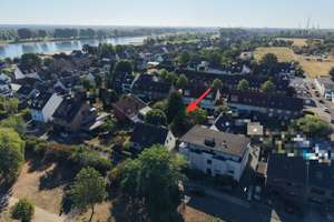 Baugrundstück in Rheinnähe mit positivem Bauvorbescheid für ein Mehrfamilienhaus und Altbestand