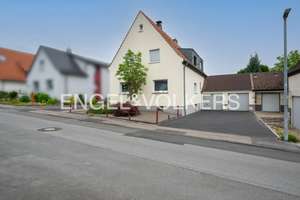 Großzügiges Zweifamilienhaus mit idyllischem Garten, zwei Garagen und viel Potenzial in Holzen