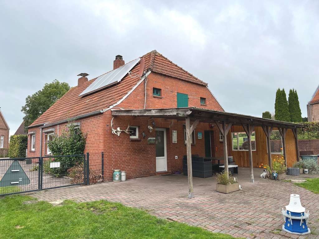 Immobilie in Ihlow - Gepflegtes Landhaus mit Nebengebäude in zentraler Wohnlage von Simonswolde - Bild 1