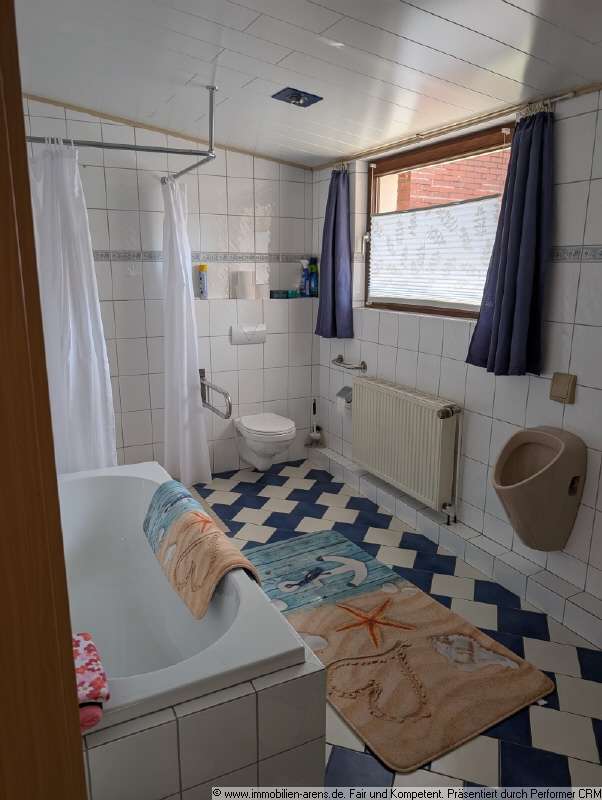 Immobilie in Apen - solides Klinkergebäude mit Garage und Wintergarten in Apen - Bild 1