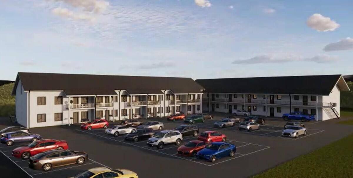 Ansicht der modernen Wohnanlage mit zahlreichen Parkplätzen und Balkonen im Grünen.