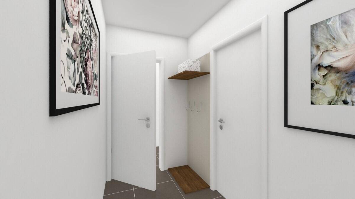 Heller Flur mit Garderobenbereich, modernen Bildern und Zugang zu weiteren Räumen.