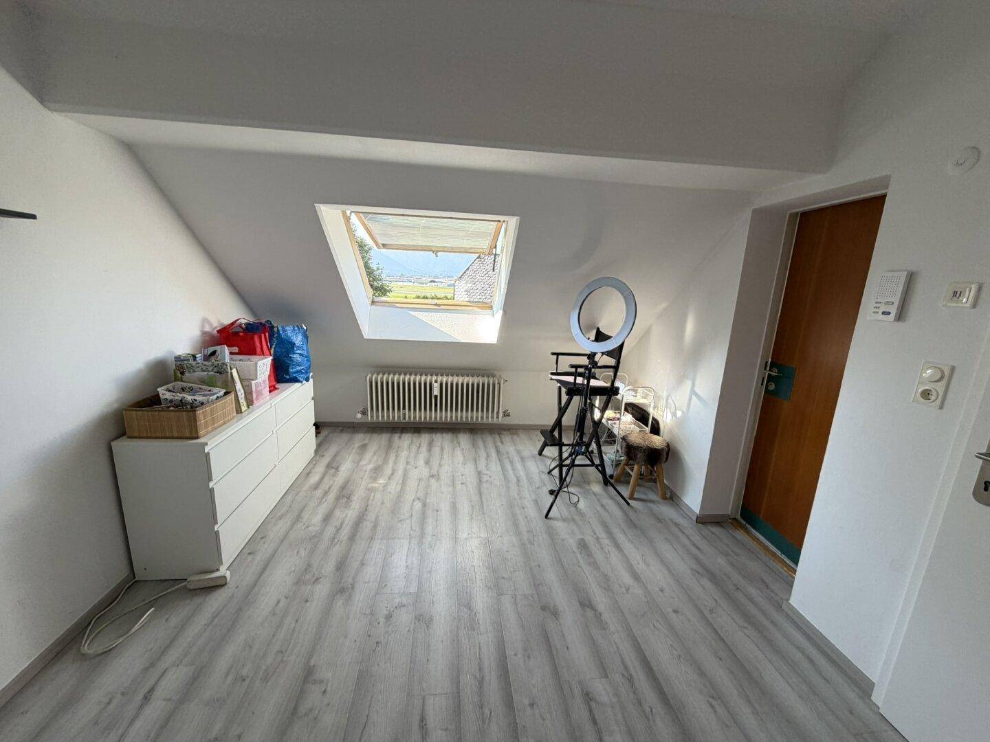 Helles Dachzimmer mit Dachfenster und Blick ins Grüne.