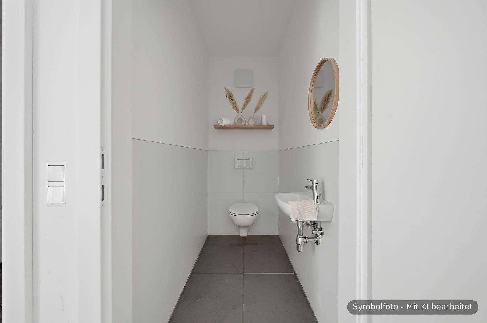 Modernes Gäste-WC mit Wand-WC, kleinem Waschbecken und stilvoller Dekoration.
