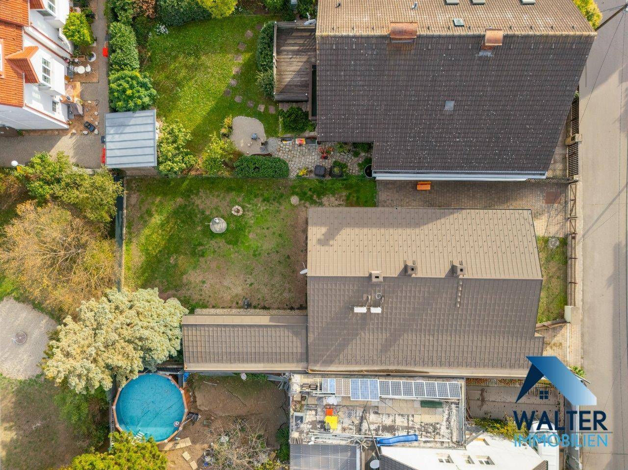 Übersichtliche Luftaufnahme des Hauses und des umliegenden Grundstücks mit Nachbarschaft.